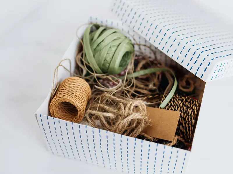 Spools of twine and string in a gift box